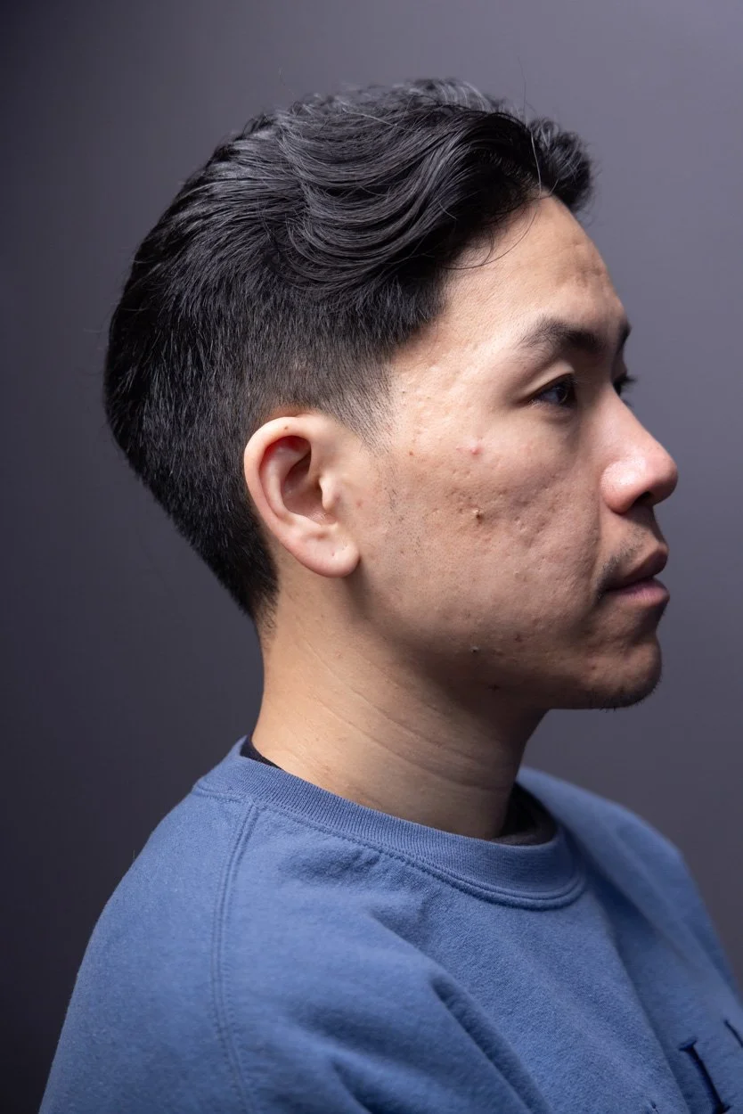 Tapered haircut with flowy bangs on Asian man. This tapered haircut features a full back tapered into the messy length on top