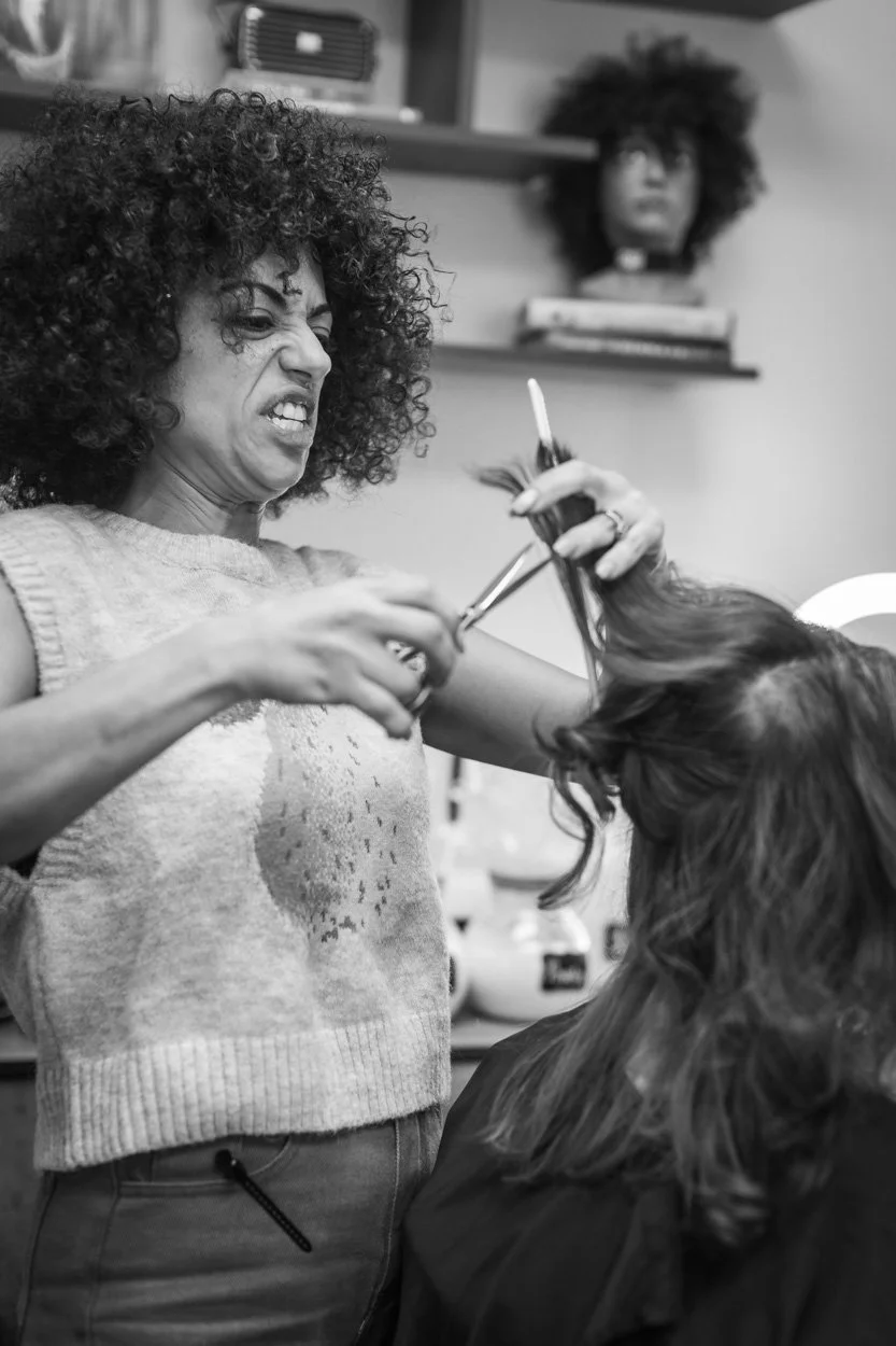Black and white photo of Egyptian woman cutting woman's hair in private hair studio in Milford connecticut