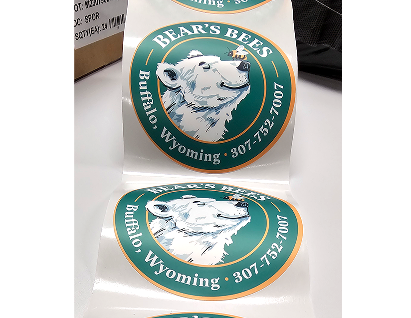 Sticker featuring a smiling white bear's head with a small bee on its nose, surrounded by the text "BEAR'S BEER" and location "Buffalo, Wyoming" with a phone number.