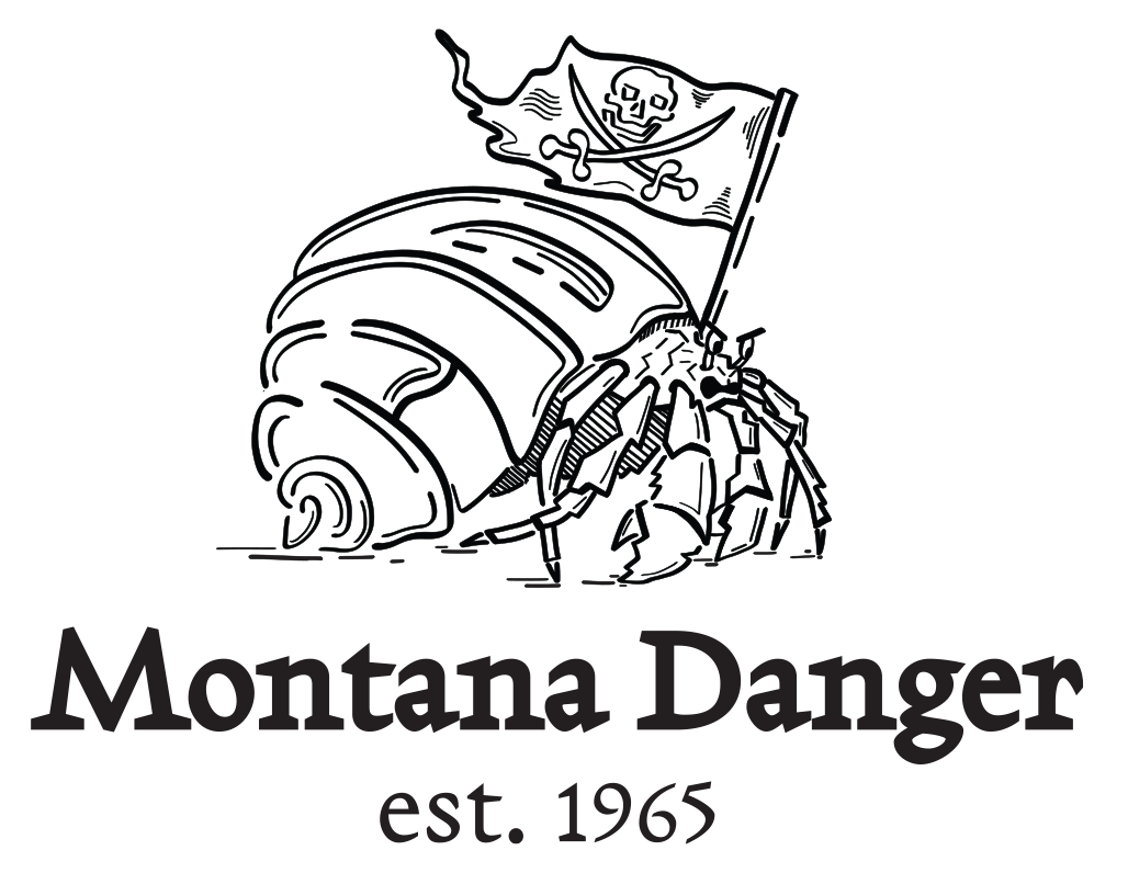 Black and white illustration of a turtle with a pirate flag on its back, with the text 'Montana Danger est. 1965' beneath.