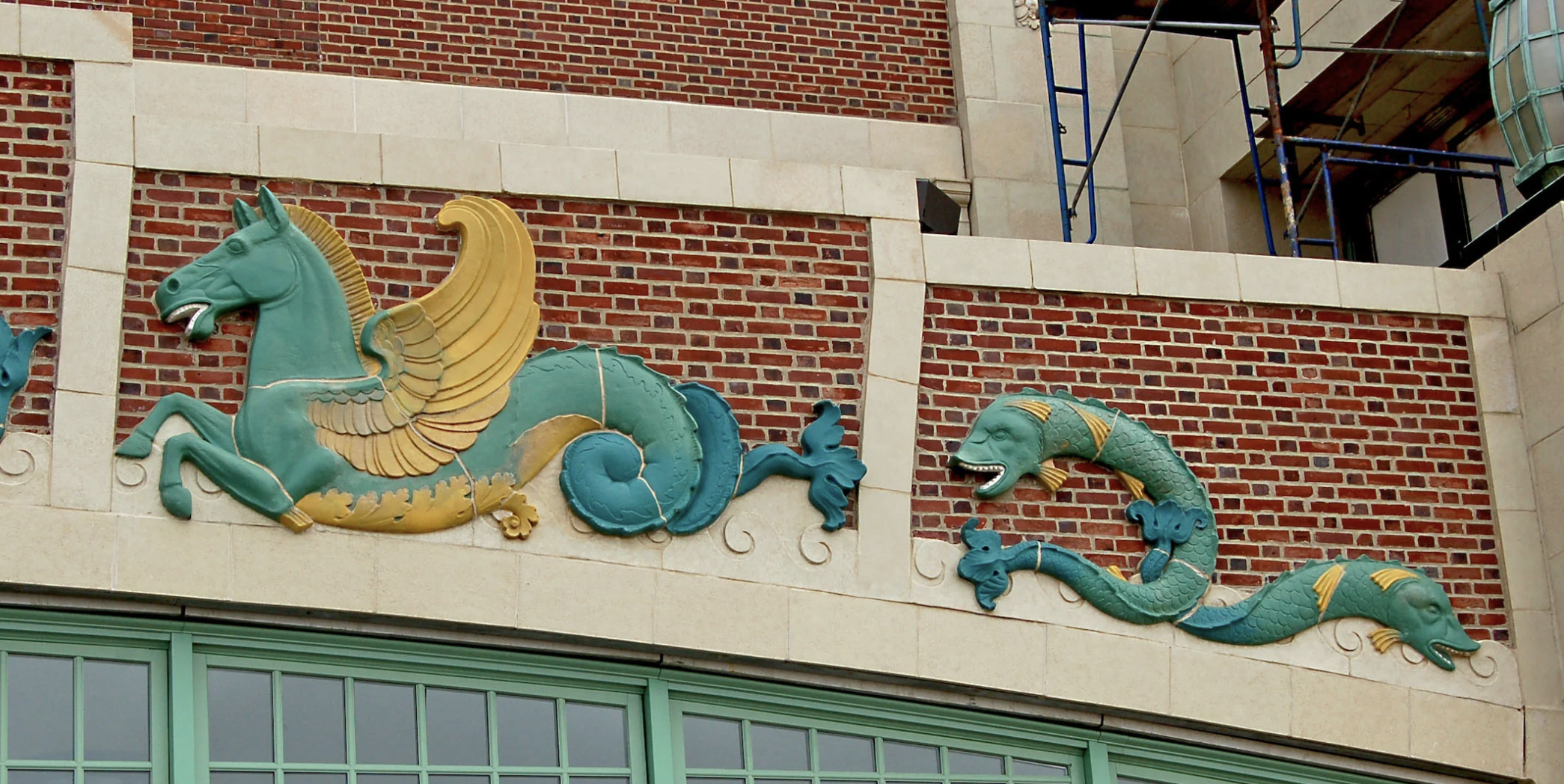 Asbury Park relief of a horse and two fish on a brick and stone building exterior.