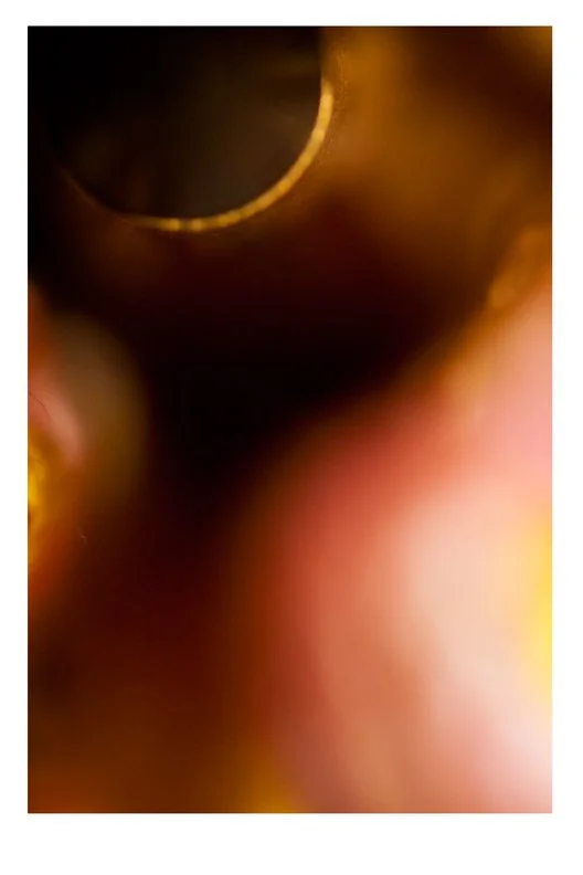 Close-up of the inside of a pipe or tube with rounded metallic edges and blurred background.