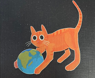An orange striped cat with big eyes and a long tail playing with a globe of the Earth on a dark background.