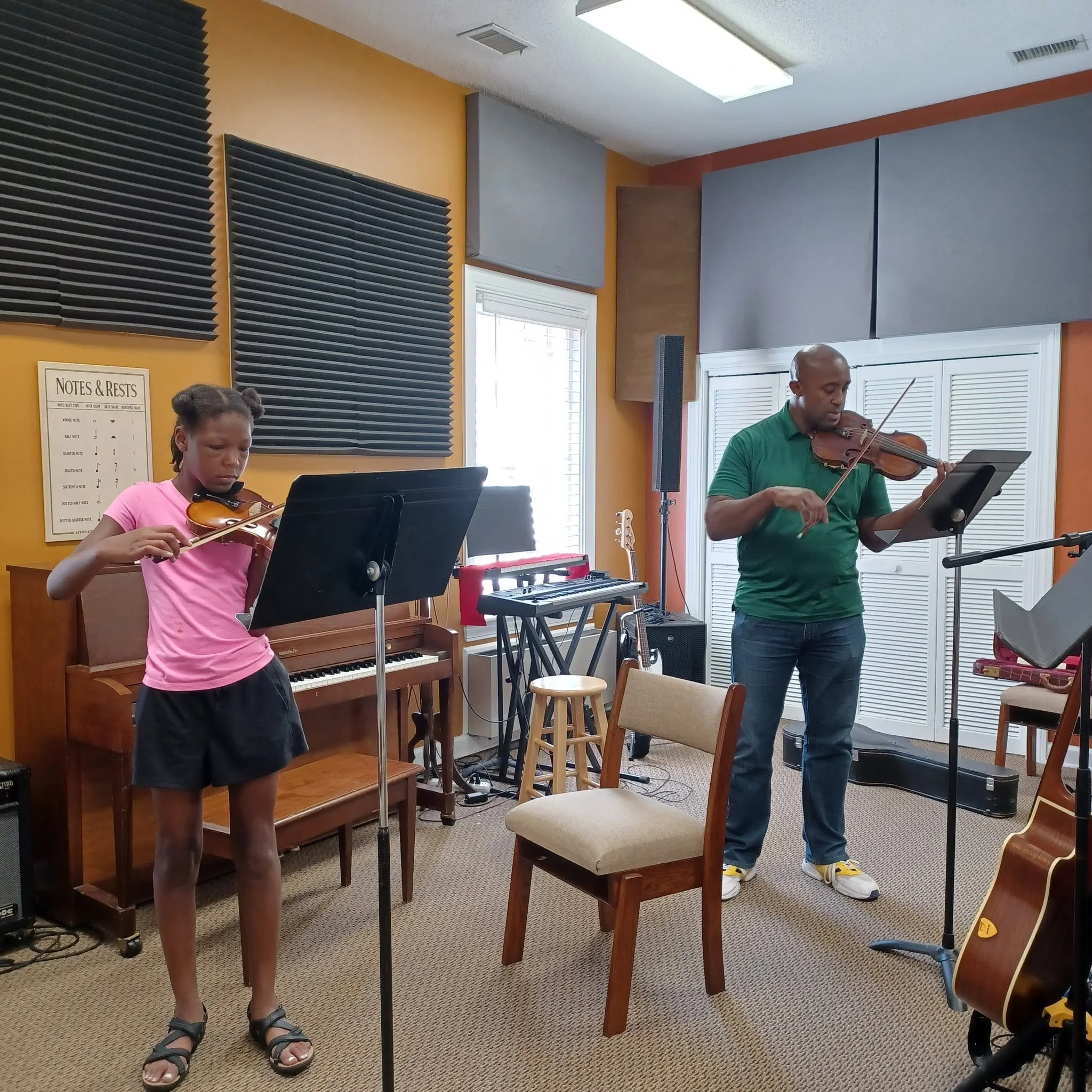 Jeff Germain and music student playing violins