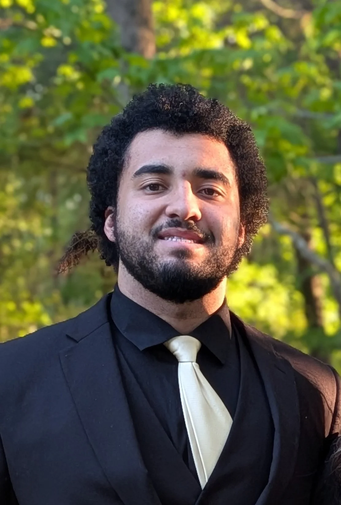 man wearing black suit and white tie