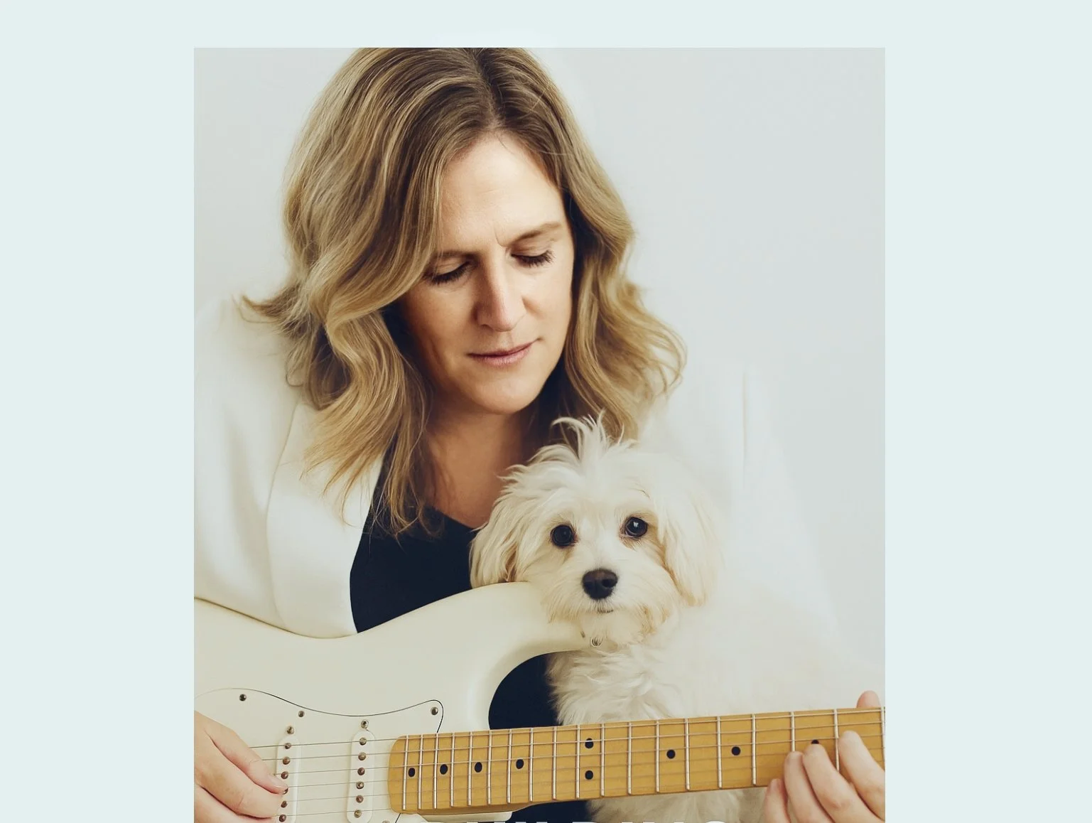 Emily Wyatt, founder of Real Estate Concierge Services, holding a small dog and smiling in a casual setting.