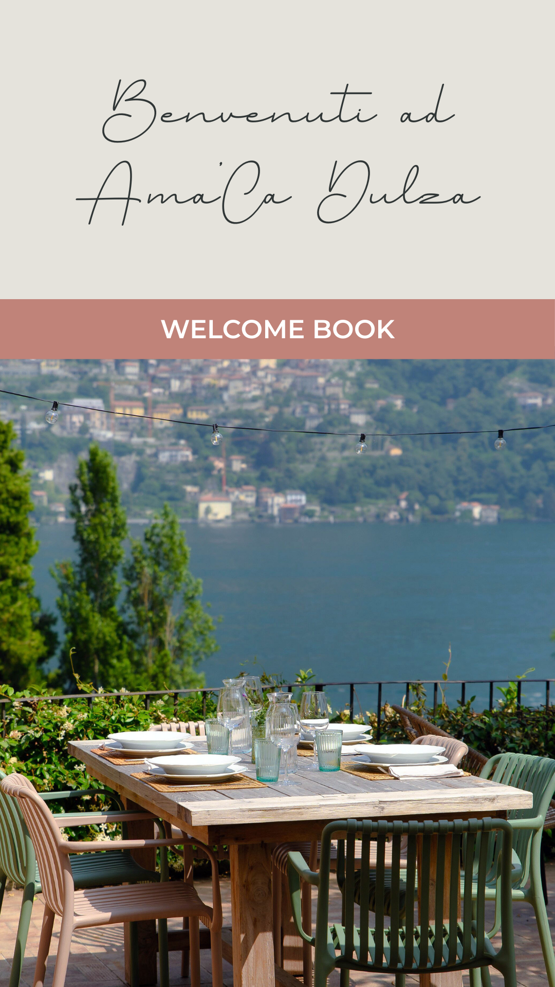 A welcome book cover with text in Italian and English, featuring a scenic outdoor dining table with a view of a lake and hillside town in the background, string lights above, and table set with plates and glassware.