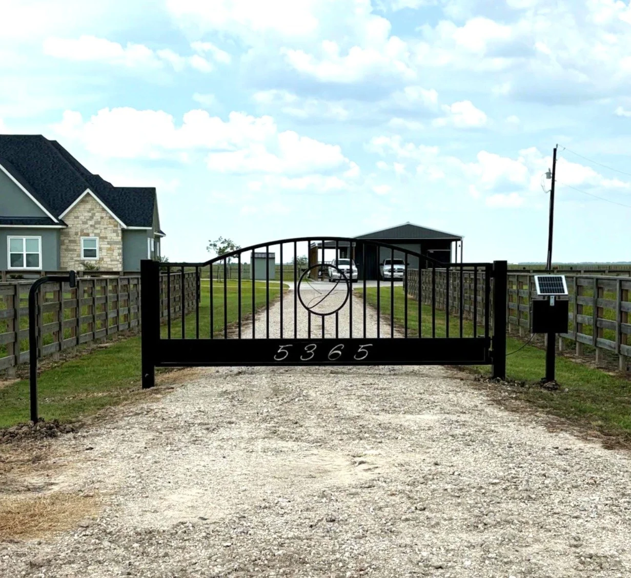 Custom automatic metal gate with initials near Needville Texas.