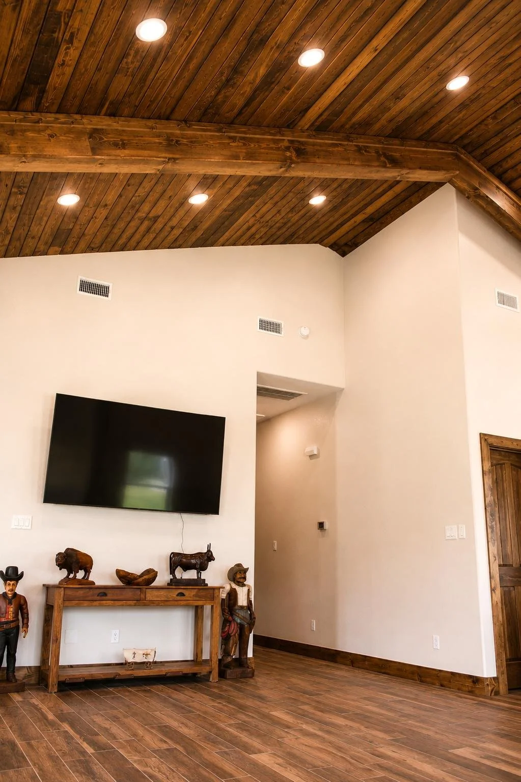 Modern rustic living space with vaulted ceilings, exposed beams, and open floor plan