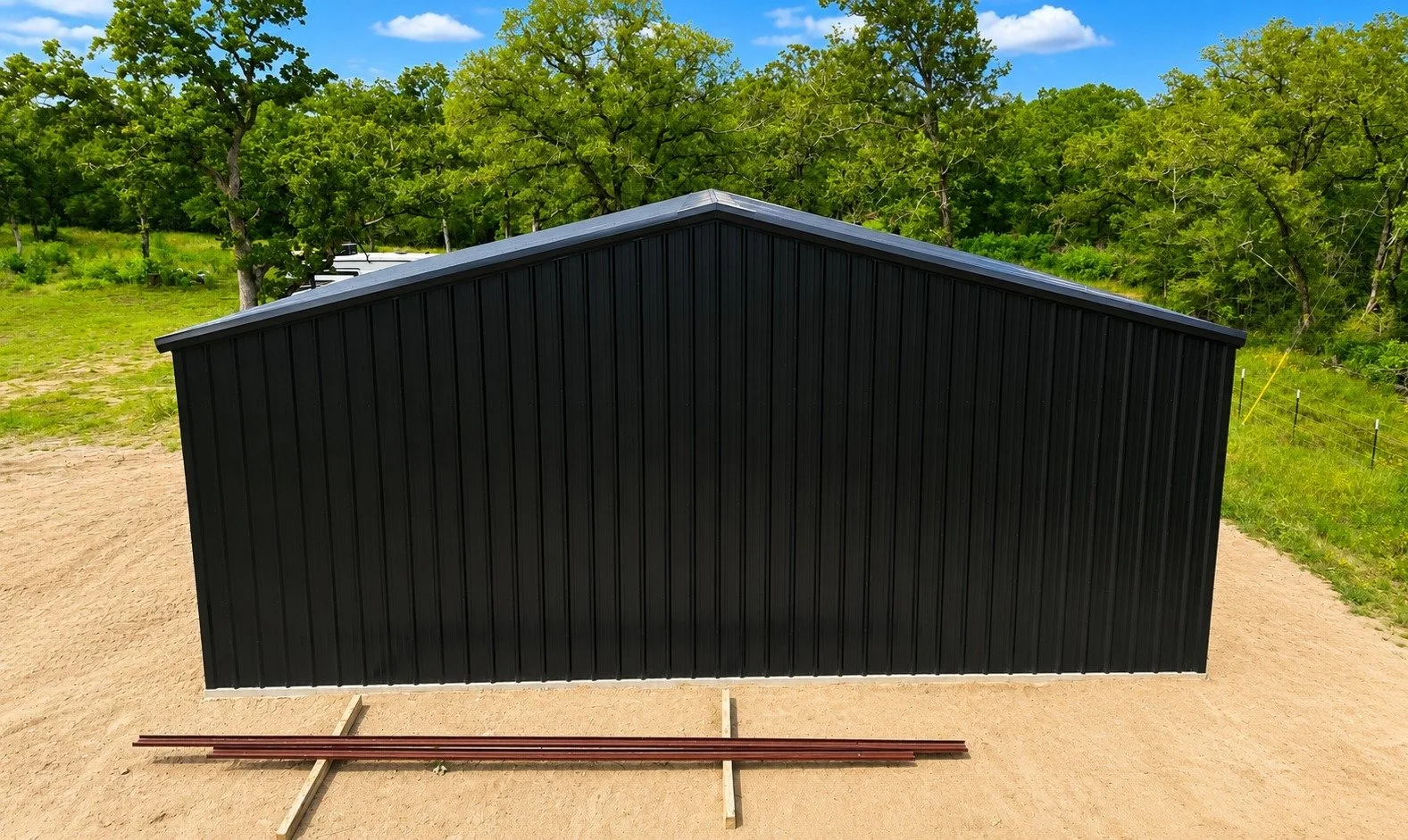 Side elevation featuring the full-length wall and durable black metal siding.