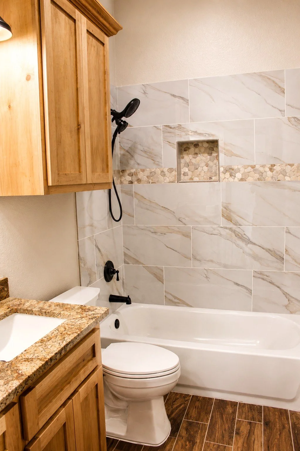 Custom tile surrounding tub in secondary bathroom inside barndominium built in South Texas.