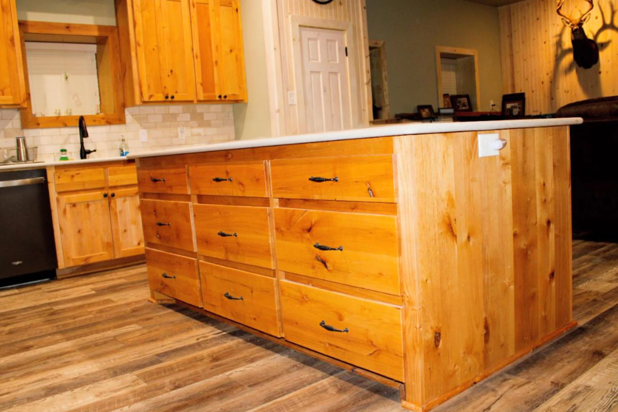 Custom kitchen island inside barndominium with lots of storage.