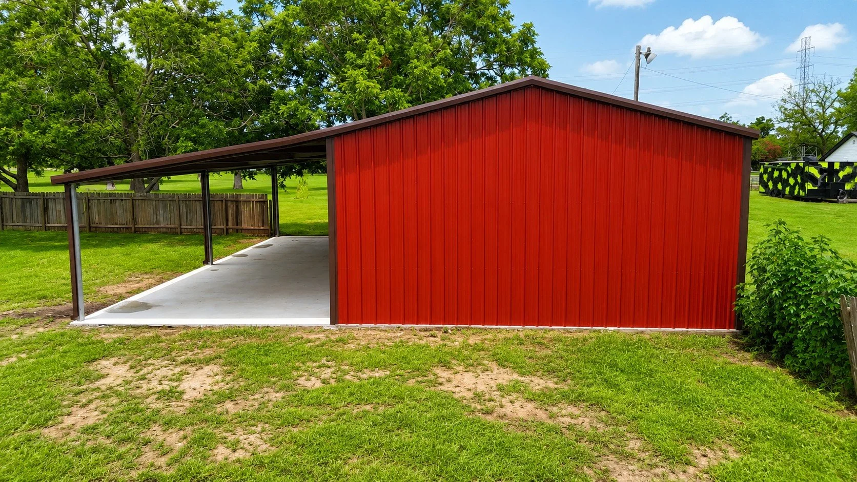 Rear view of the completed 30' x 50' custom metal shop featuring Rustic Red siding, Coffee Brown trim, two white roll-up doors, and a full 20' x 50' covered lean-to.