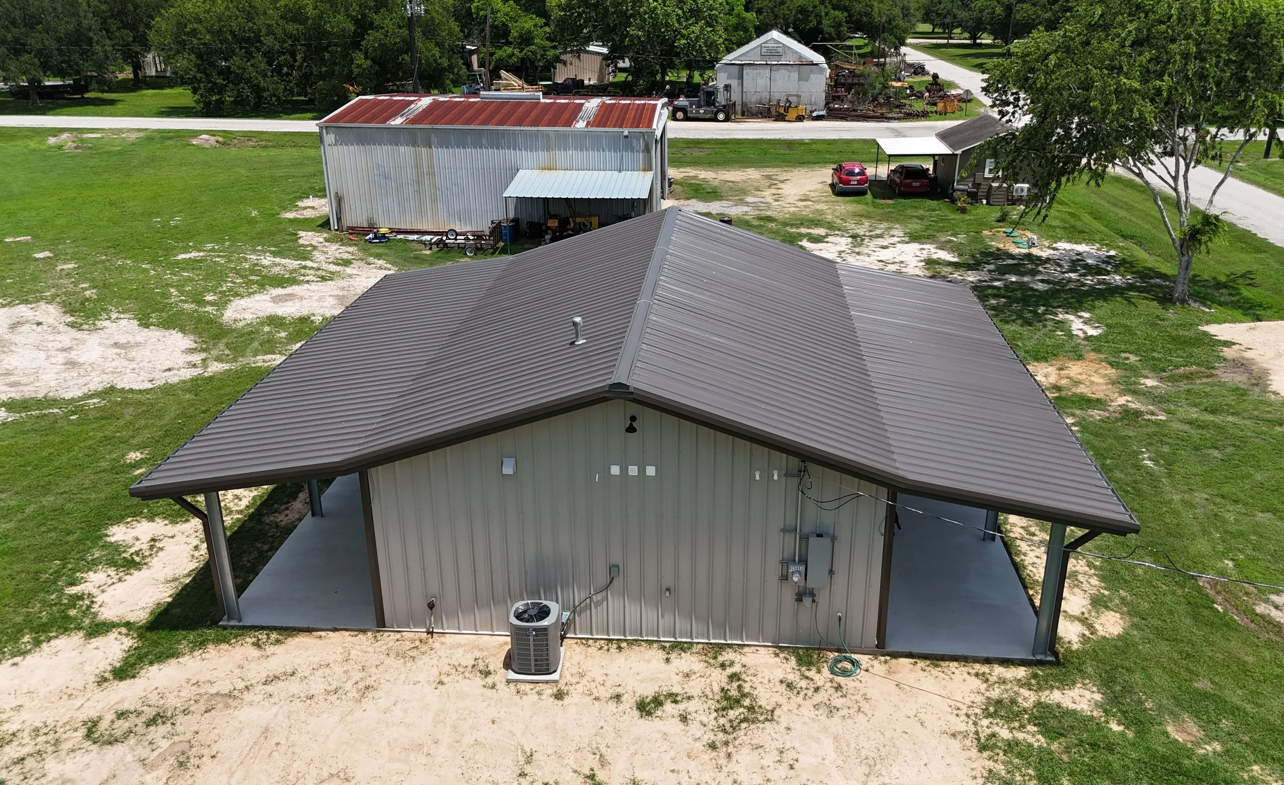 Aerial side view of bolt up metal barndominium in Wharton County, TX.