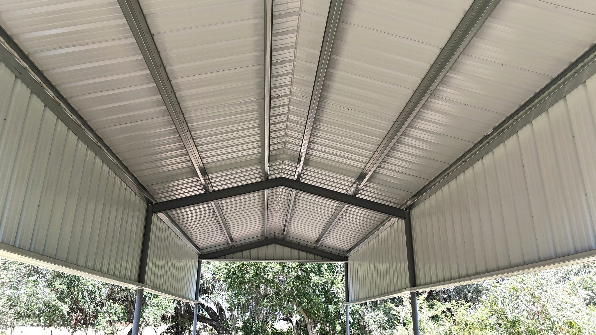Interior view of the weld-up steel frame, galvanized roof purlins, and metal side skirts that provide strength and additional weather protection.