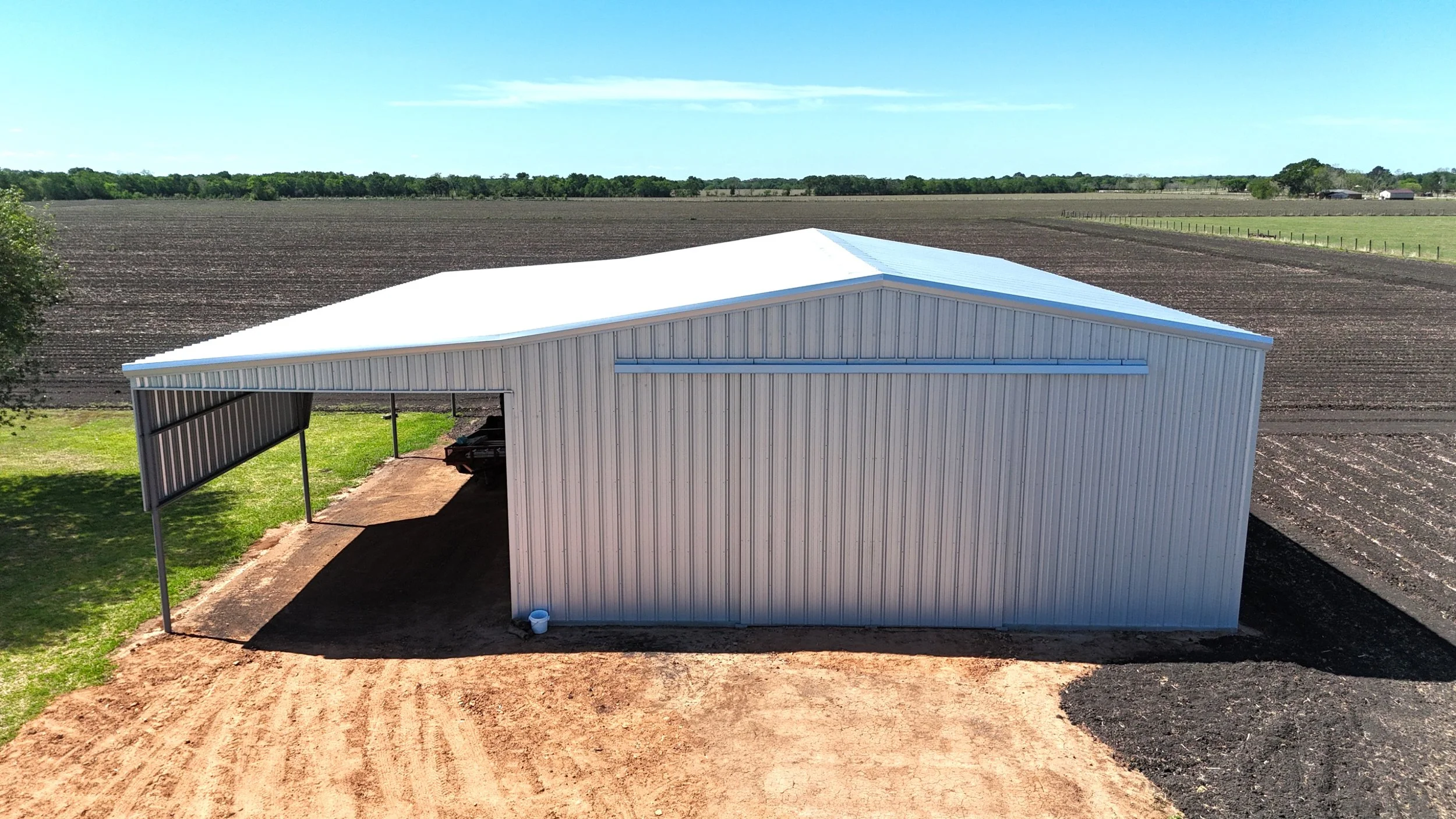 40x60 agricultural metal building with lean-to, fully galvalume exterior, East Bernard TX, front elevation view