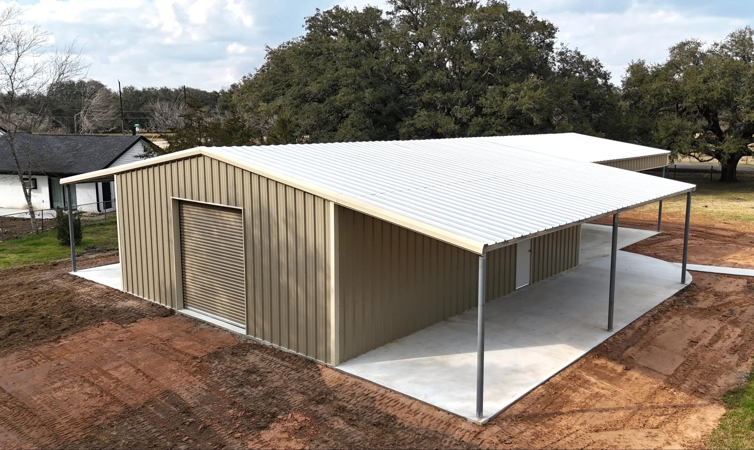 Side elevation of metal building showing dual lean-to and color-matched wall panels in Damon, TX.