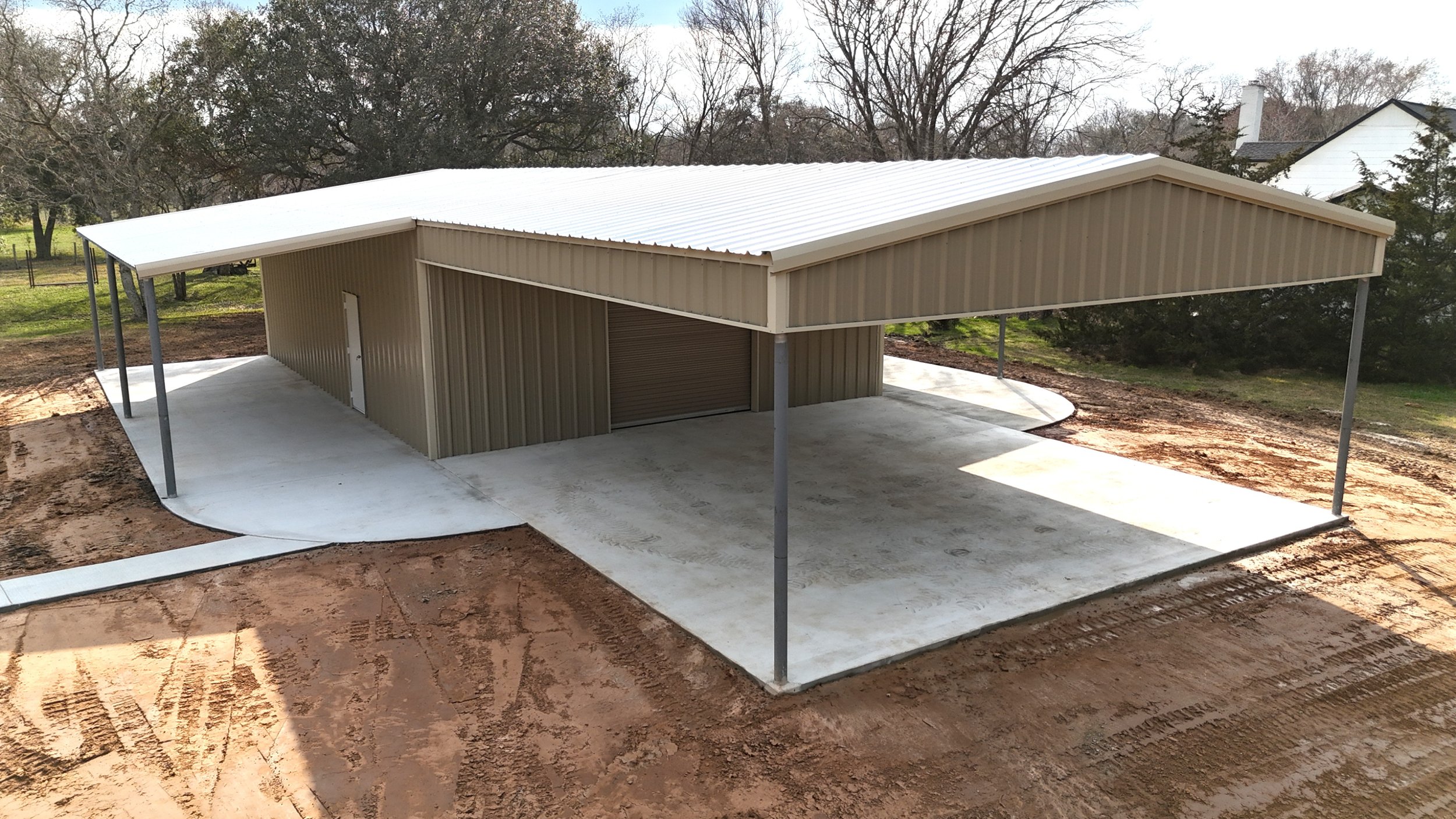 Front view of metal building highlighting large awning and open covered workspace in Brazoria County, TX.