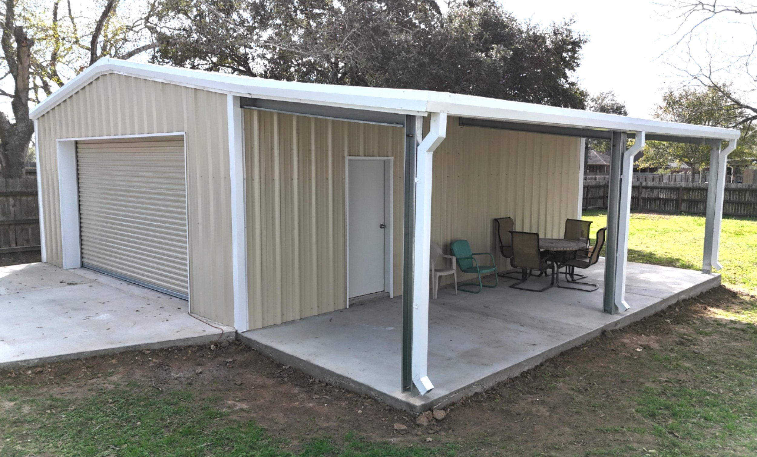 Corner view showing the integration of the wraparound porch with the enclosed shop and garage.