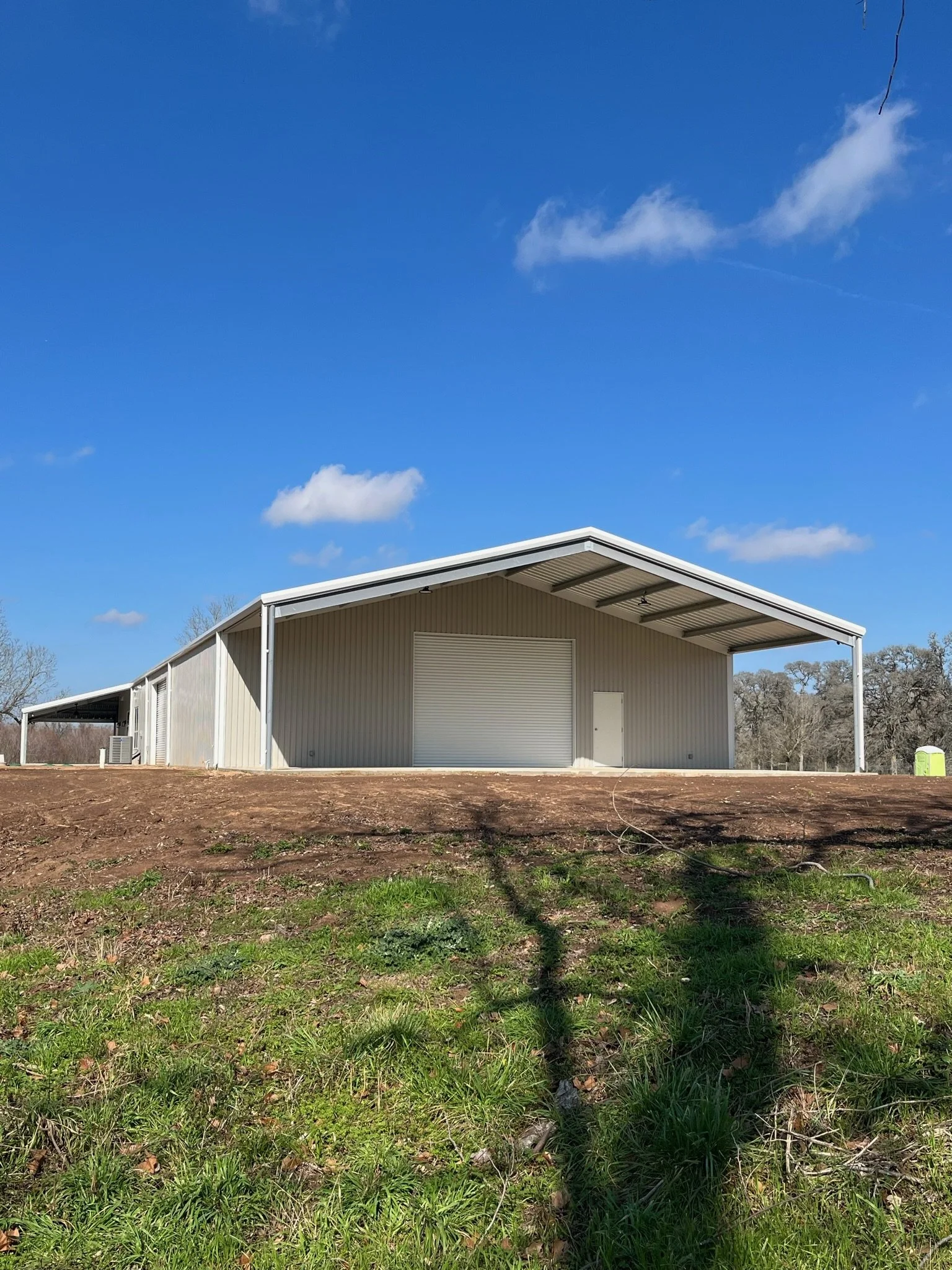 Large metal shop/garge with front awning and rear lean-to in South Texas