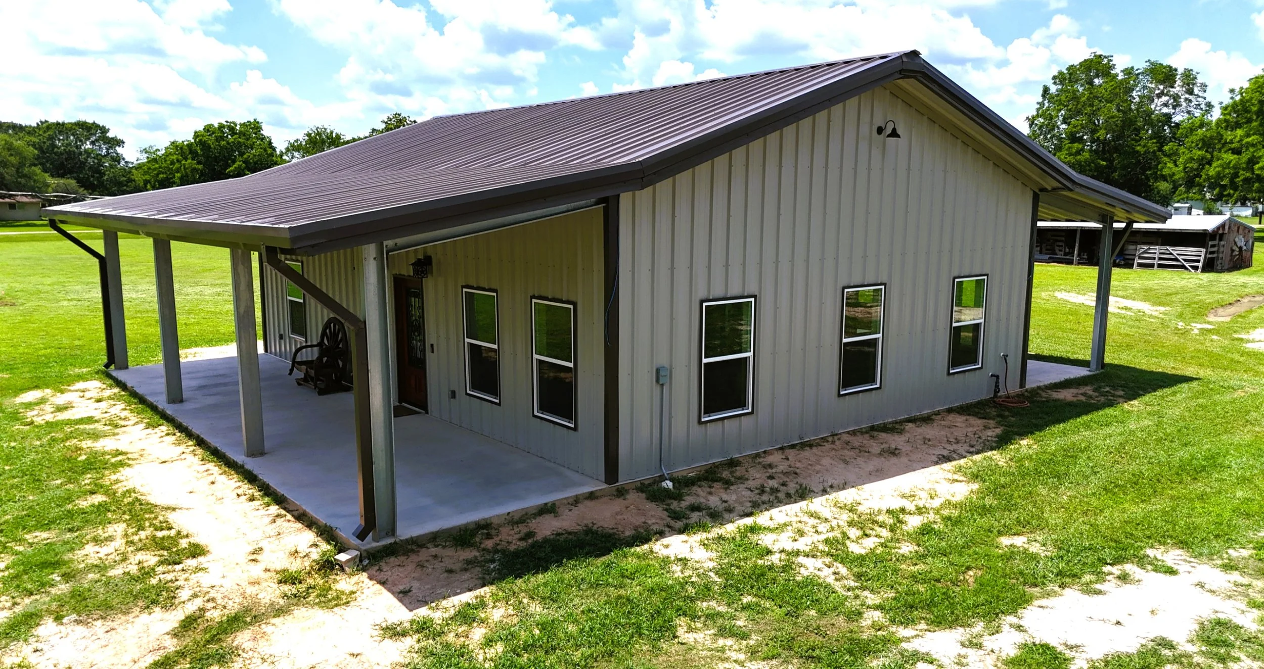 Side view of dual porches on this metal barndominium built in Lissie, TX
