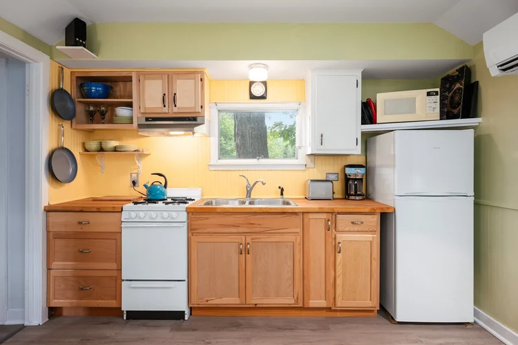 Kitchen with wood cabinets, gas range and refrigerator