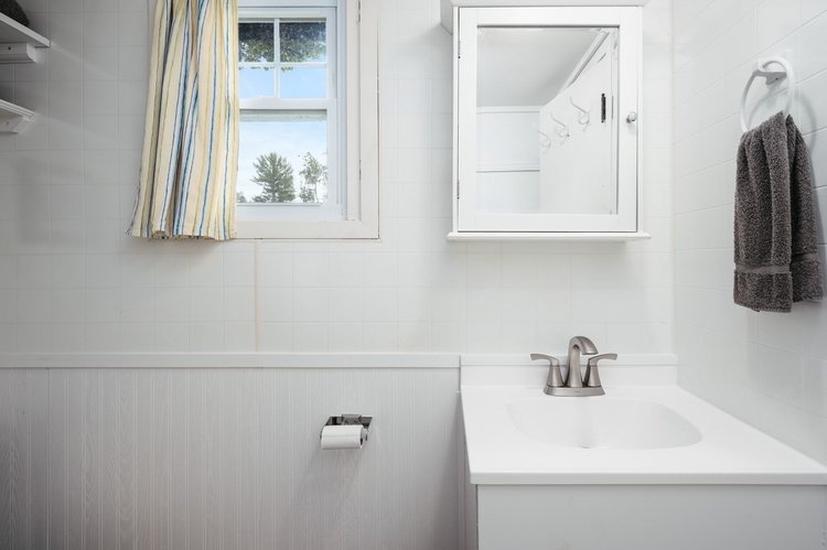 Bathroom with white vanity and medicine cabinet