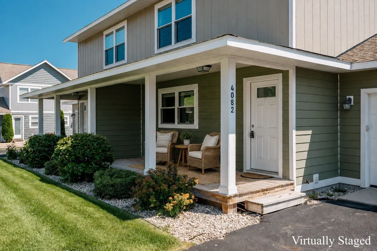 Covered front porch and entry door, virtually staged