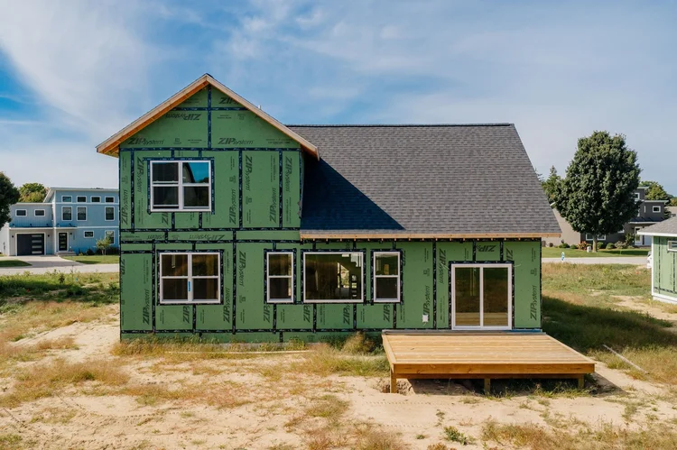 Back of the home with a wood deck