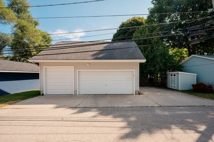Three-stall garage and concrete parking pad
