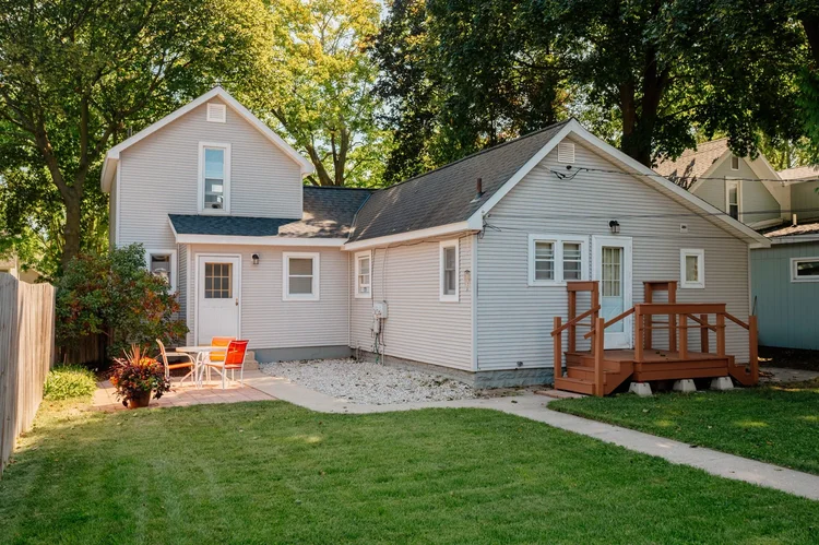 Back of the home with deck and patio