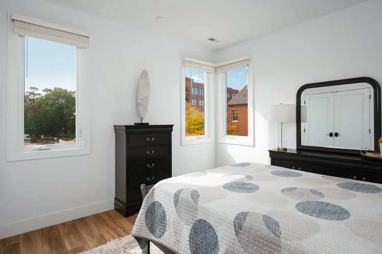 Bedroom with windows and dresser