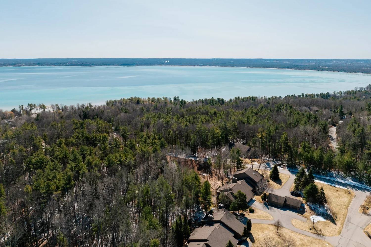 Aerial view of Port of Old Mission condos in the woods above East Bay