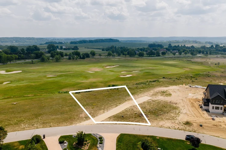 Outlined lot seen from the street toward the golf course