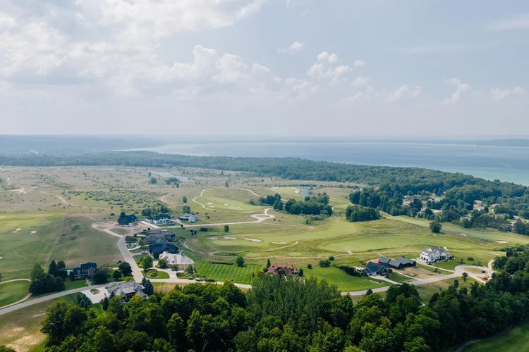 Aerial of the neighborhood, golf course and bay