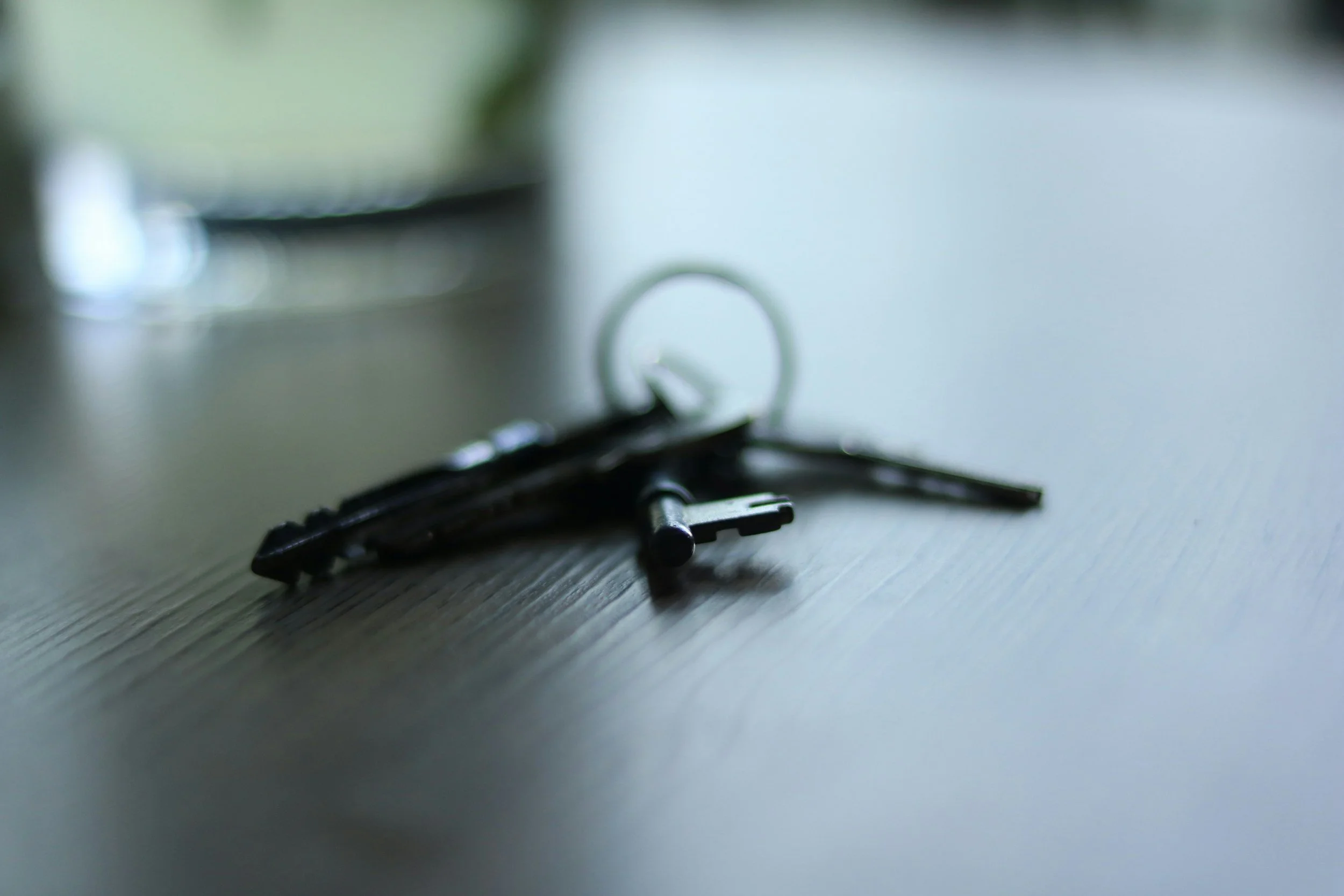 Set of house keys on a dark wooden table