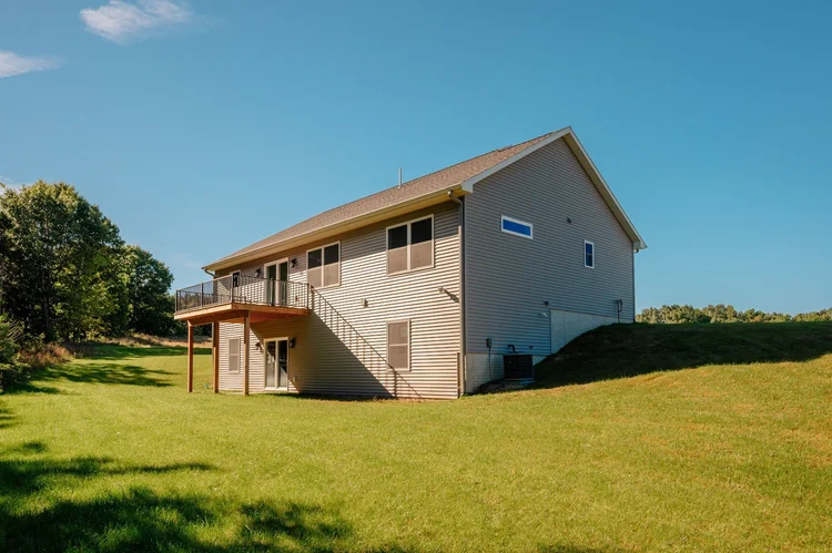 Rear of home with raised deck and walkout level