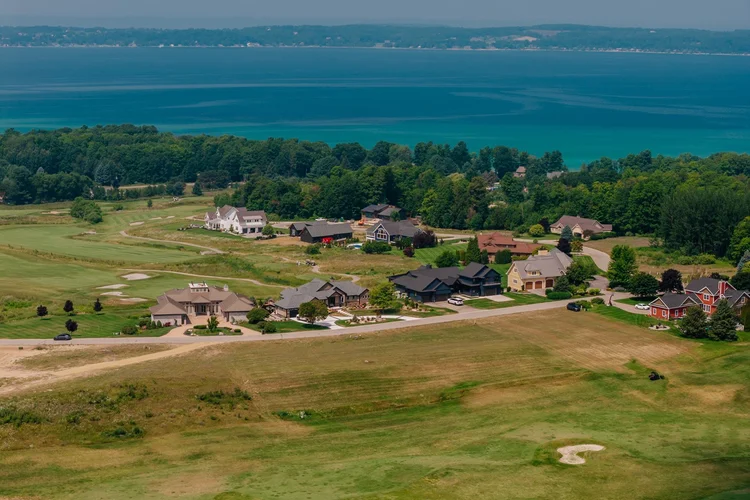Aerial of neighborhood homes with the bay beyond