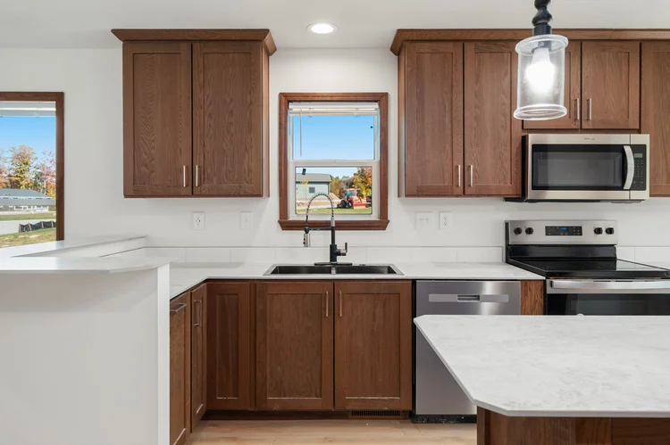Kitchen with white counters and stainless appliances