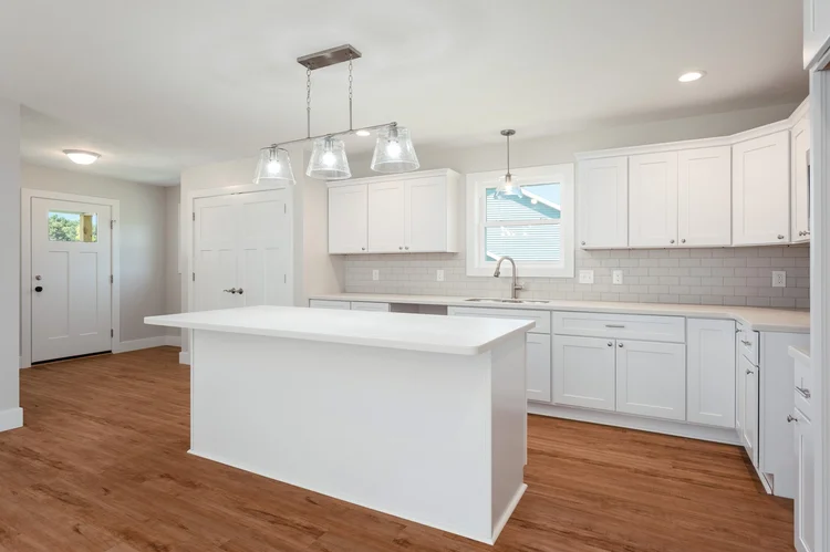 Kitchen with white cabinets and center island