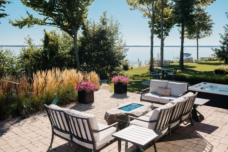 Patio with fire pit seating and hot tub