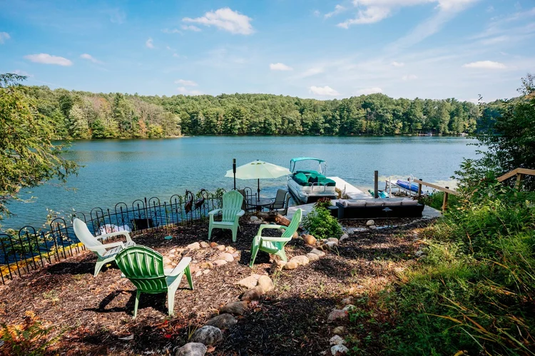 Chairs at the shoreline looking across Chandler Lake