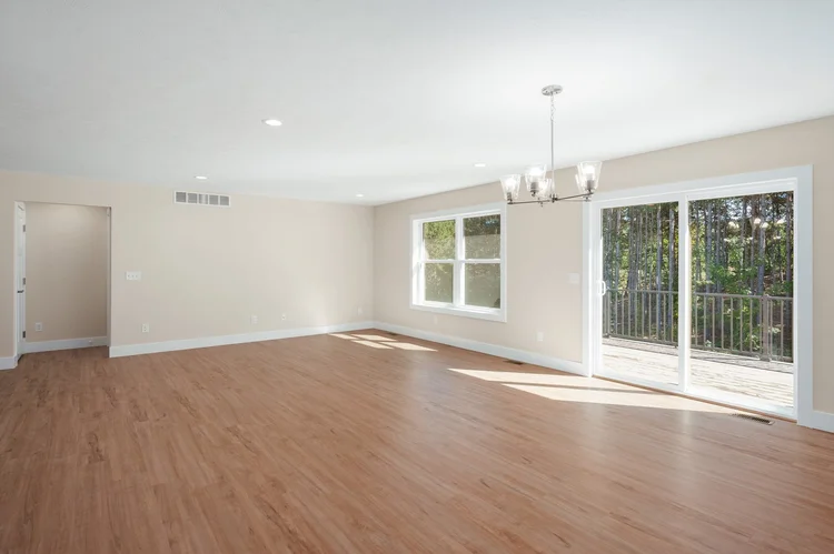 Open living and dining area with sliding door