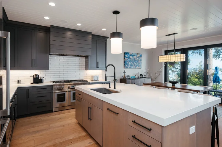 Kitchen with dark cabinets and large white island