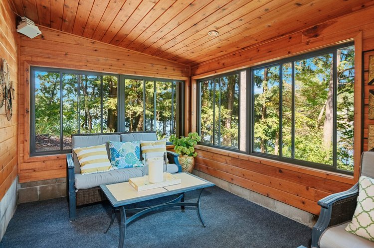 Cedar-lined seasonal room with windows toward the lake