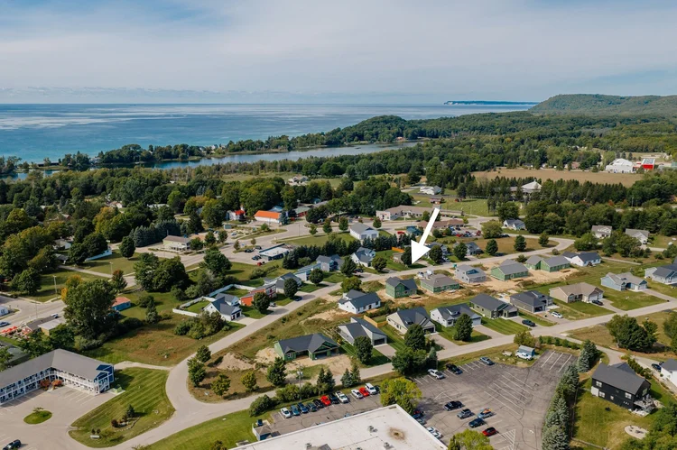 Aerial of the neighborhood with arrow marking the home