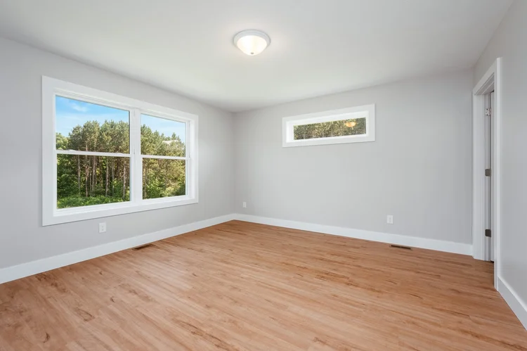 Primary bedroom with large window and transom window