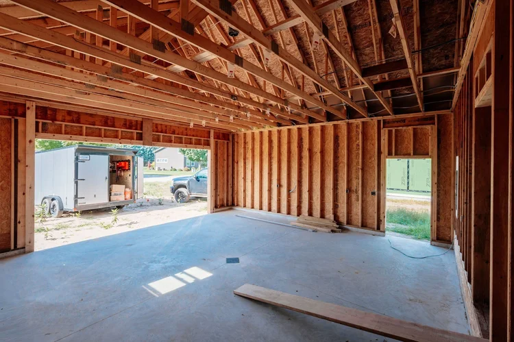 Framed garage interior with open overhead door