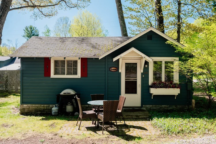Front of the cottage with patio table and grill