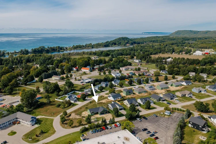 Aerial of the neighborhood with an arrow marking the home